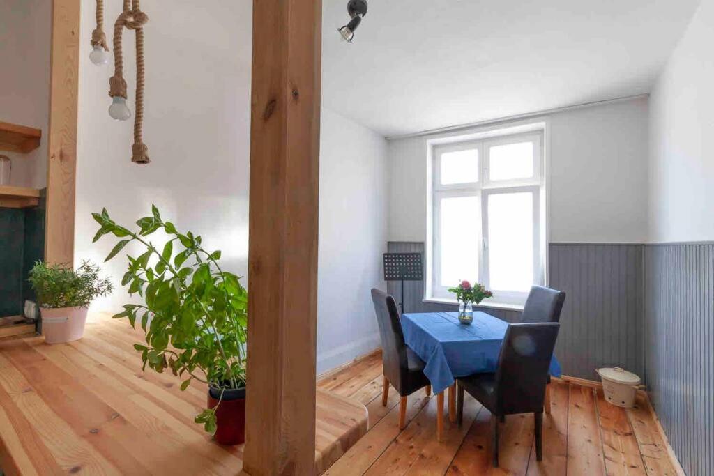 a dining room with a blue table and chairs at City Apartment in Lübeck