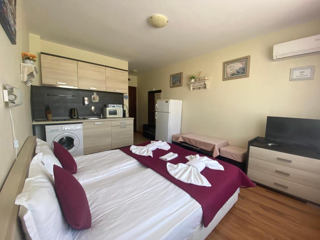 A bed or beds in a room at SUMMER BREEZE 406 Studio Sunny Beach