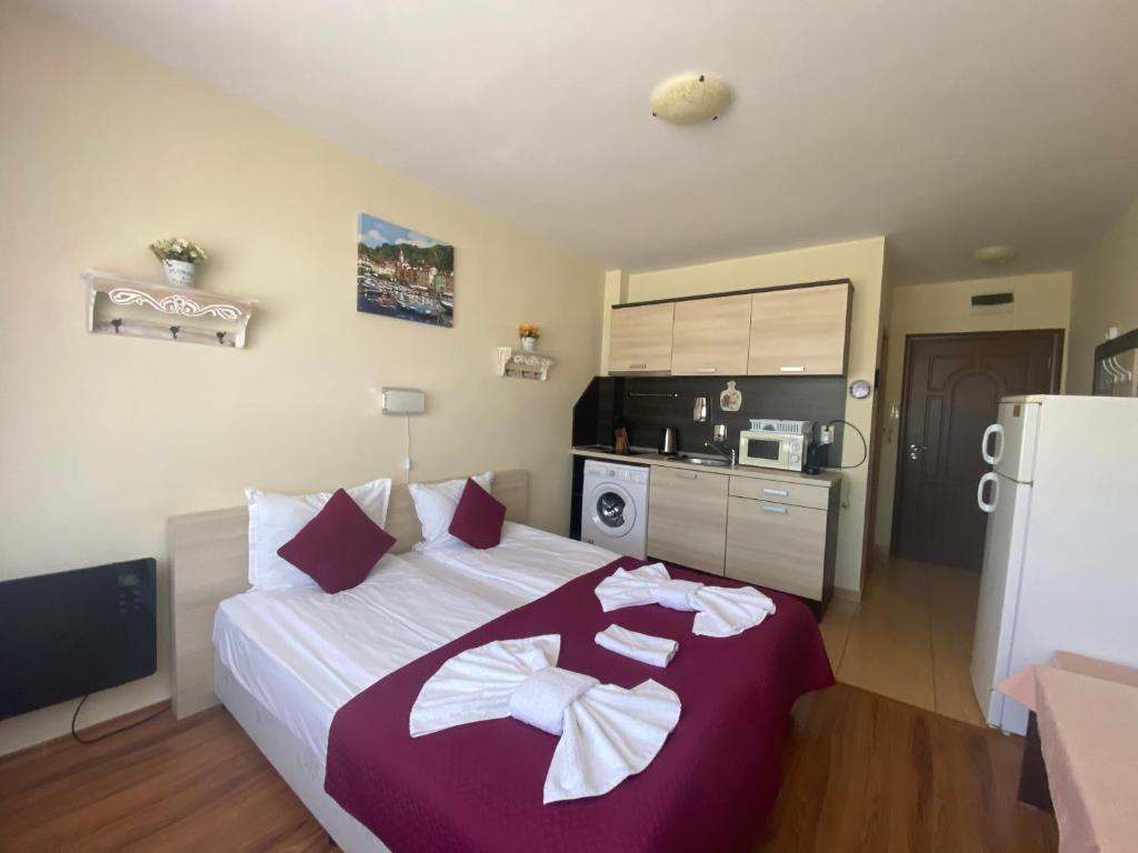A bed or beds in a room at SUMMER BREEZE 406 Studio Sunny Beach
