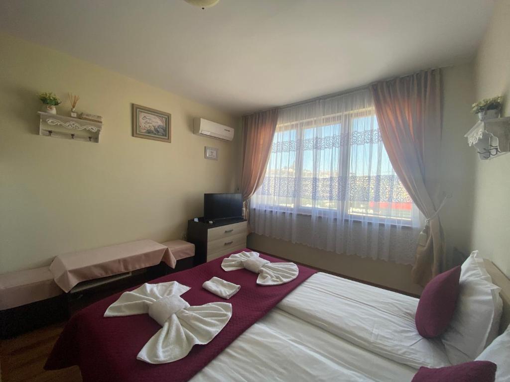 A bed or beds in a room at SUMMER BREEZE 406 Studio Sunny Beach