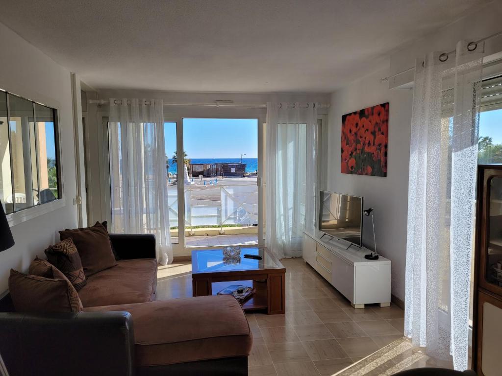 een woonkamer met een bank en een televisie bij CAP HERMES 3 Pieces Climatise 6 Personnes in Fréjus