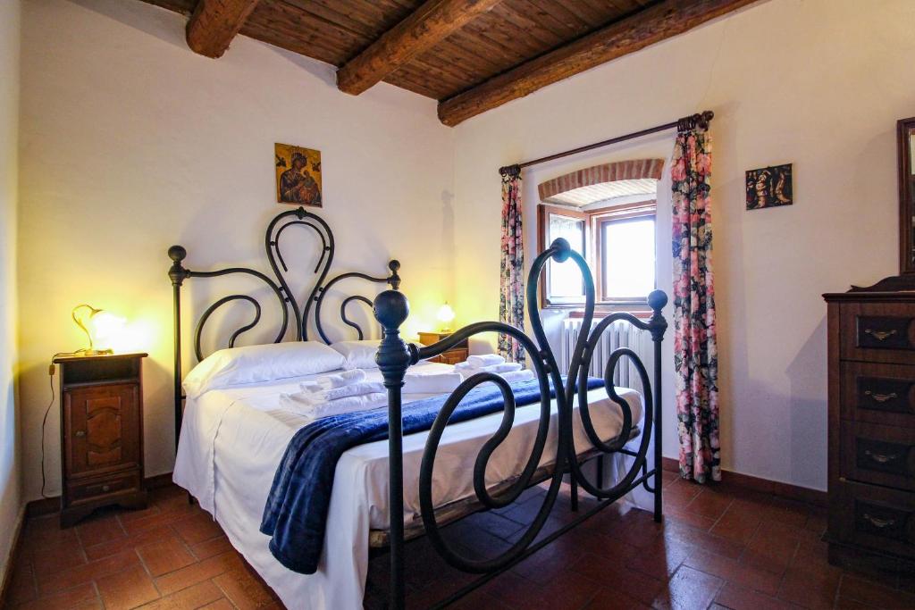 a bedroom with a bed with a wrought iron frame at Santo'S House BnB in Santo Stefano di Sessanio