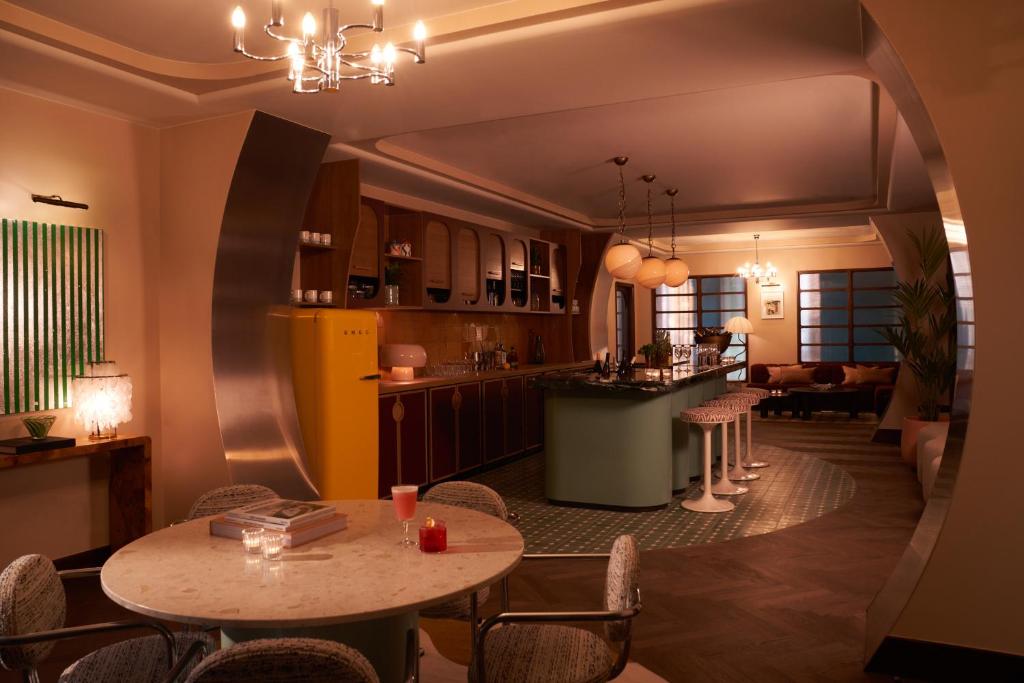 a kitchen and dining room with a table and chairs at The Hoxton, Brussels in Brussels