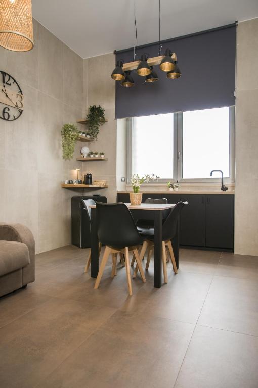 a kitchen and dining room with a table and chairs at suite 18 luxury apartments in Bari
