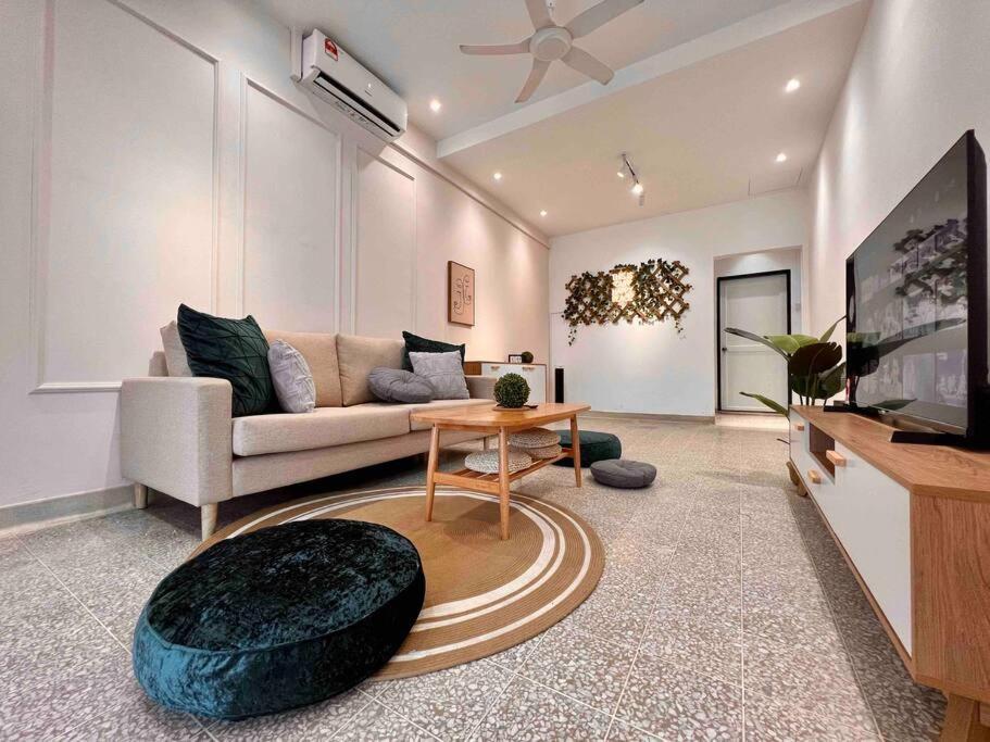 a living room with a couch and a tv at Petaling Jaya SS2 Seapark Landed House, 4BedRoom, for 12 Pax with Netflix in Petaling Jaya