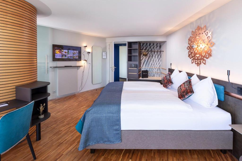 Uma cama ou camas num quarto em Sedartis Swiss Quality Hotel