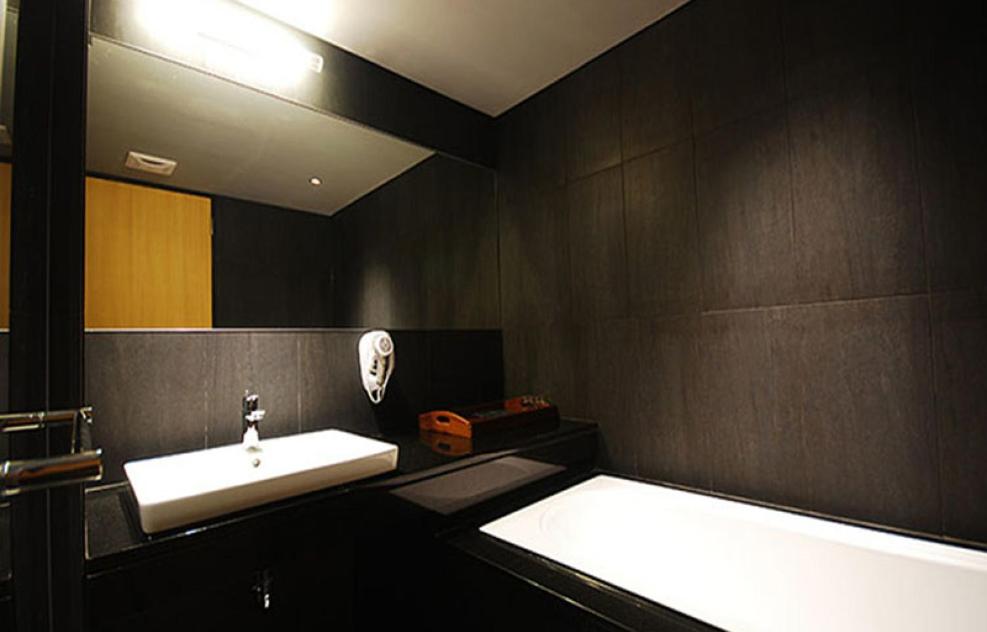 a bathroom with a sink and a mirror at Chiayi Guanzhi Hotel in Chiayi City