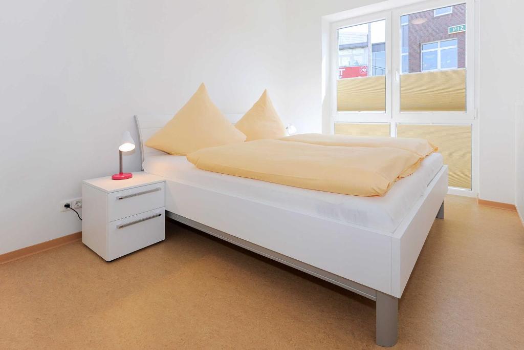 Postel nebo postele na pokoji v ubytování Haus Leuchtturm