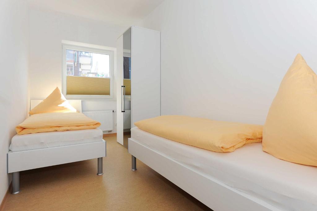 Postel nebo postele na pokoji v ubytování Haus Leuchtturm