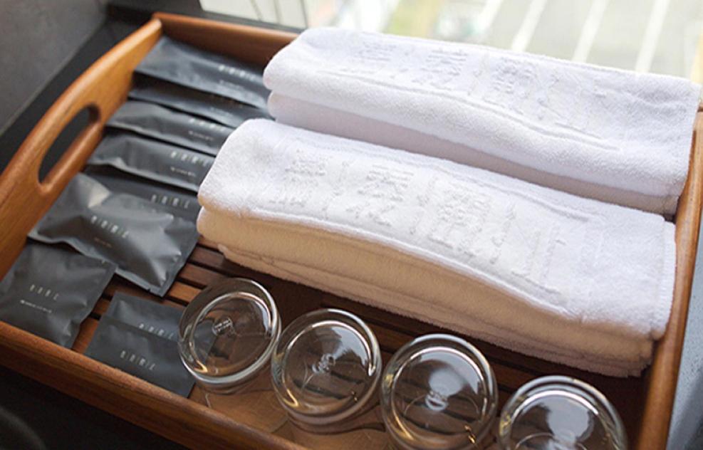 a wooden drawer with towels and utensils at Chiayi Guanzhi Hotel in Chiayi City