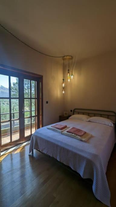 a bedroom with a bed and a large window at Villa Khaki 