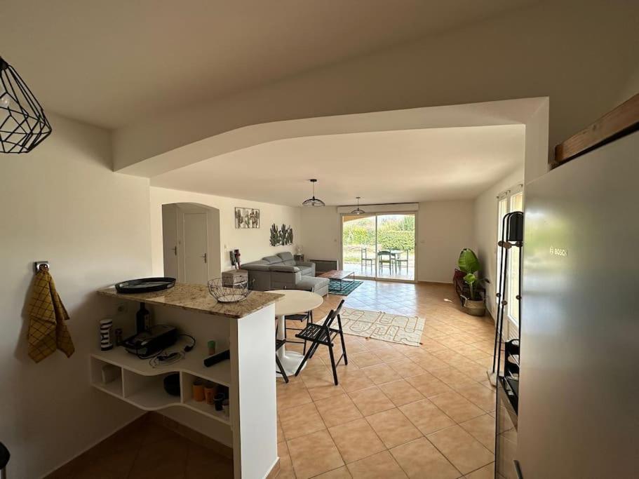 Il comprend une cuisine et un salon avec une table et des chaises. dans l'établissement Grande annexe de maison avec jardin, à Aix-en-Provence