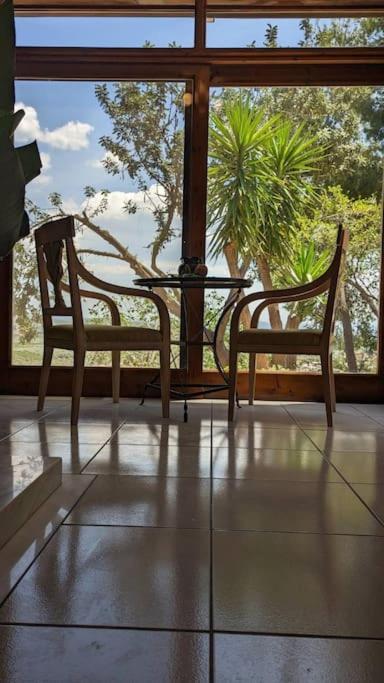 a room with two chairs and a table and a window at Villa Khaki 