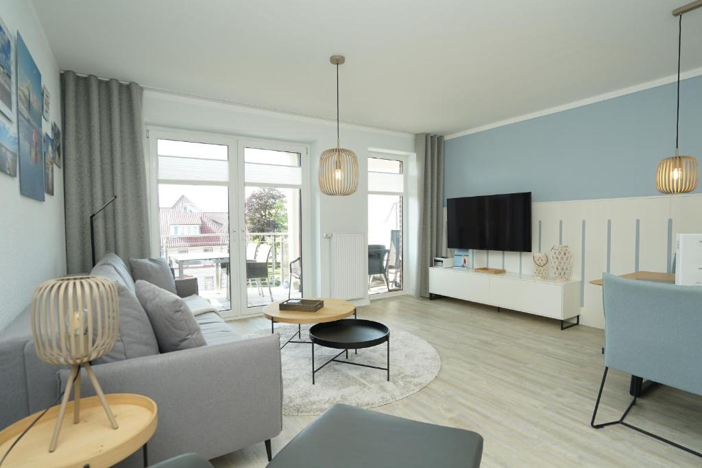 a living room with a couch and a tv at Seeblick - a57219 in Cuxhaven