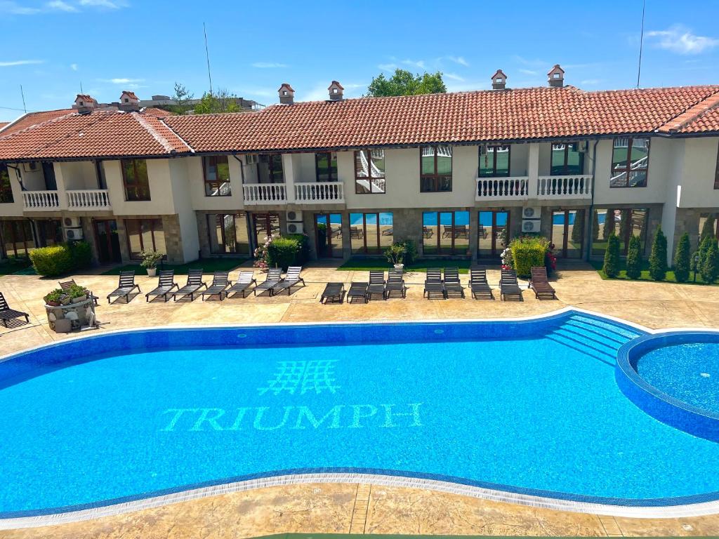 a swimming pool in front of a building at Apartment Marina beach k-s Triumph in Sveti Vlas