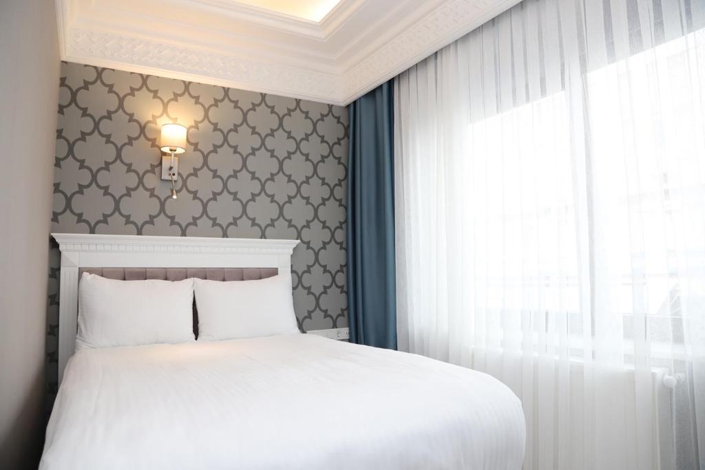 Postel nebo postele na pokoji v ubytování Novus Hotel İstanbul