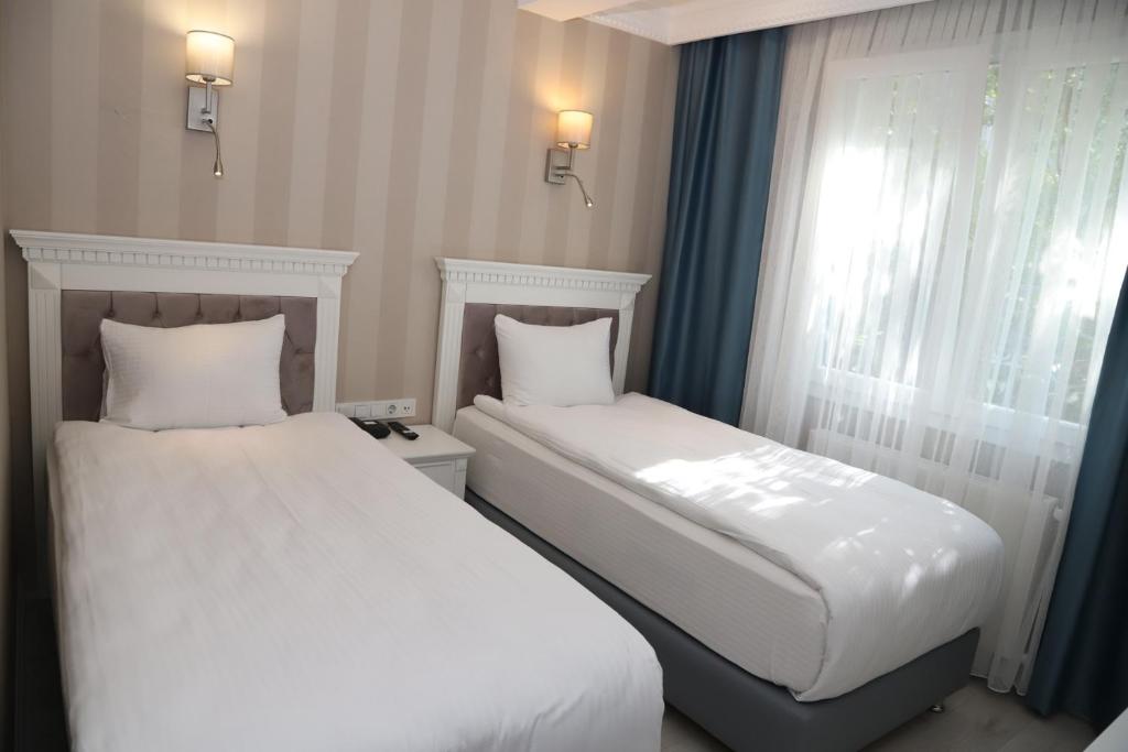 Postel nebo postele na pokoji v ubytování Novus Hotel İstanbul
