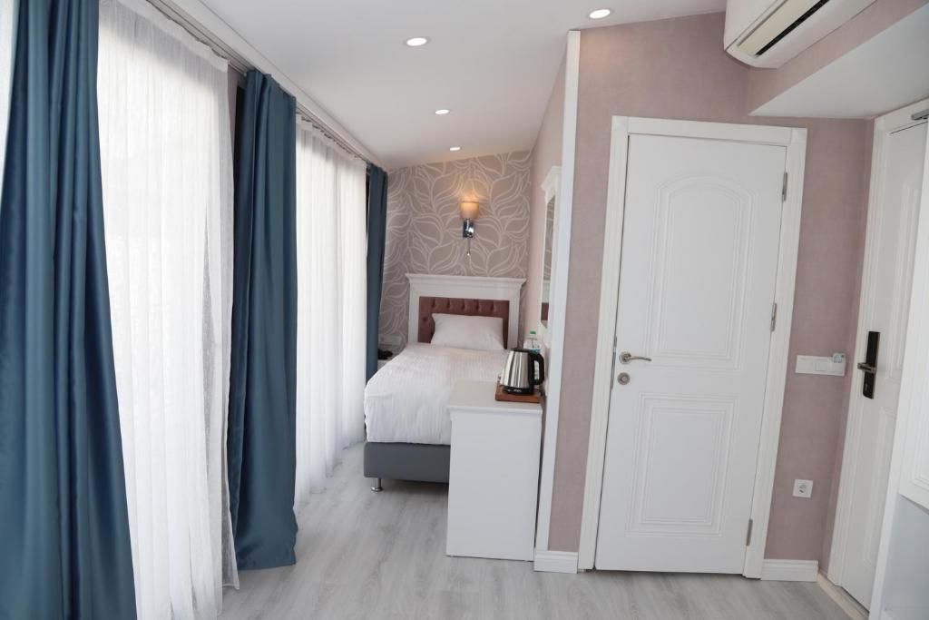 Postel nebo postele na pokoji v ubytování Novus Hotel İstanbul
