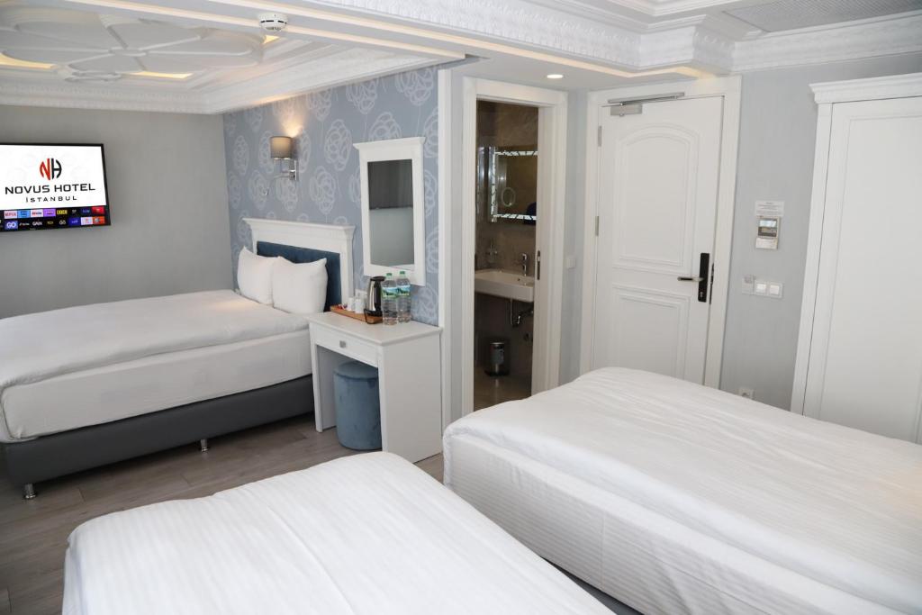 Postel nebo postele na pokoji v ubytování Novus Hotel İstanbul