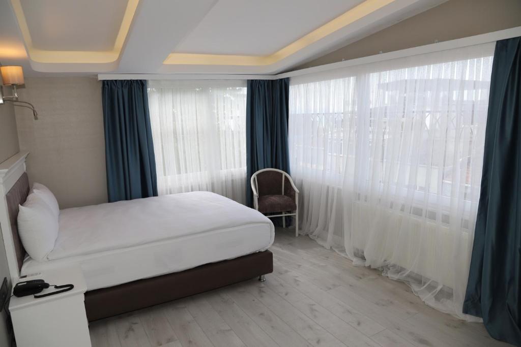 Postel nebo postele na pokoji v ubytování Novus Hotel İstanbul