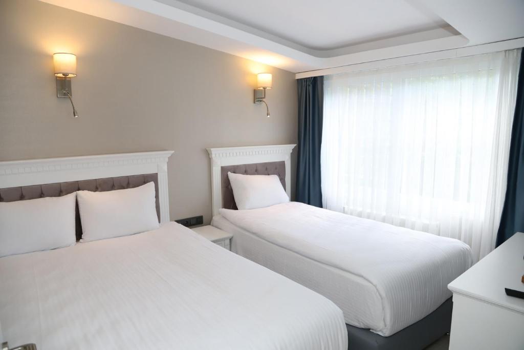 Postel nebo postele na pokoji v ubytování Novus Hotel İstanbul