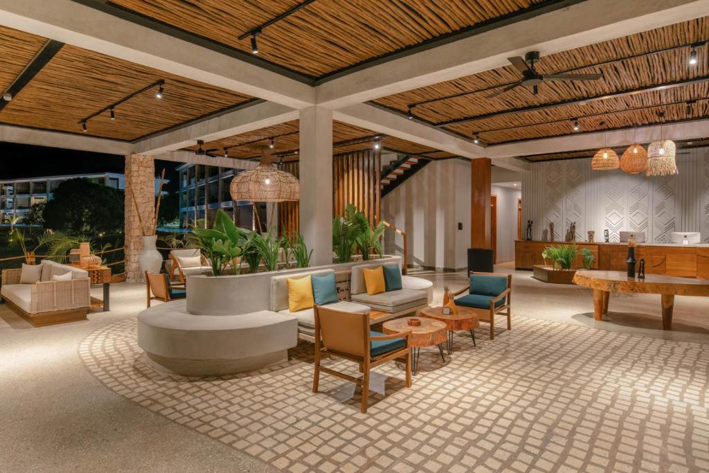 a lobby with a couch and chairs and a table at Aldiana Club Zanzibar Kwanza in Kizimkazi
