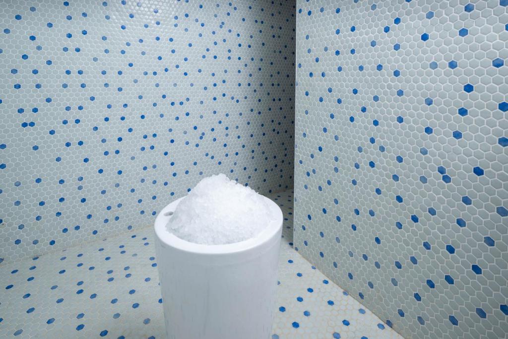 a white pillar in a room with a wall with blue dots at Aldiana Club Zanzibar Kwanza in Kizimkazi