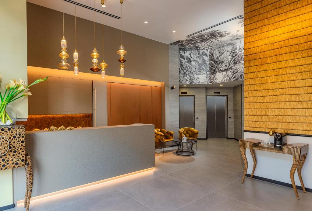 a lobby with a reception desk and chairs at Numa Hotel Jaffa in Tel Aviv