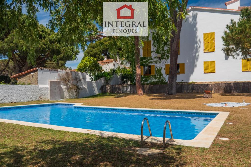 a swimming pool in front of a house at La Masia de la Fosca in Palamós