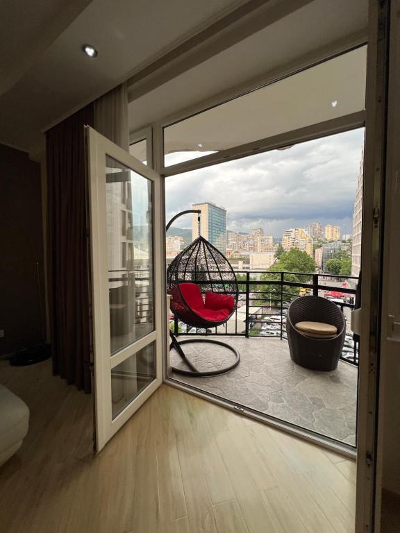 a room with a balcony with a swing at Lost in Tbilisi in Tbilisi City