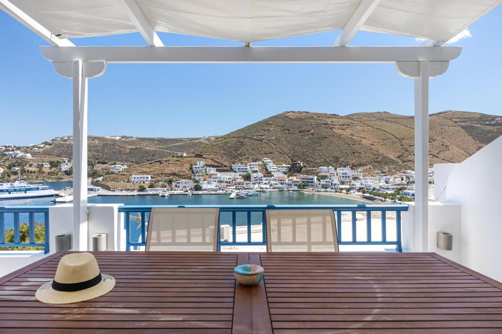 a hat sitting on a wooden deck with a view at My Kythnos House in Kithnos