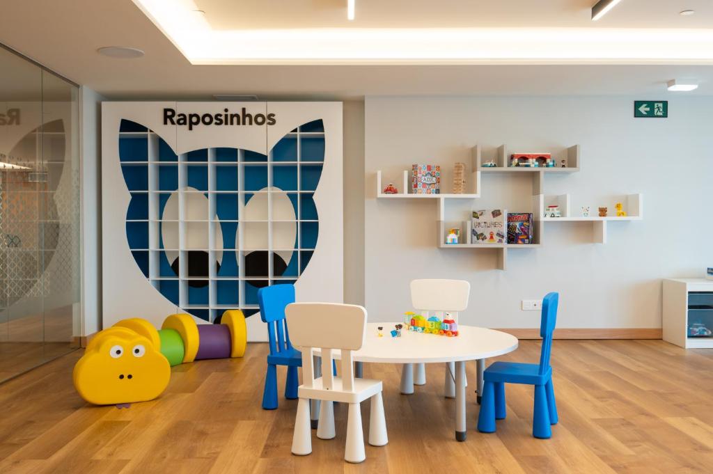 a childrens play room with a table and chairs at Martinhal Lisbon Oriente in Lisbon
