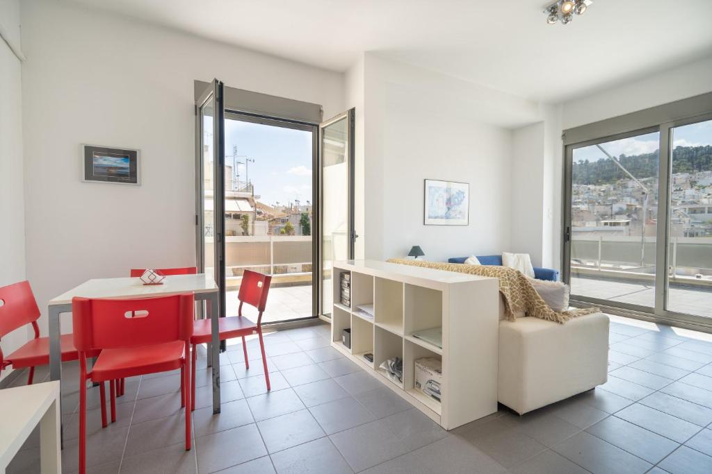 a living room with a bed and a table and chairs at Athens city center maisonette for 3 persons by MPS in Athens