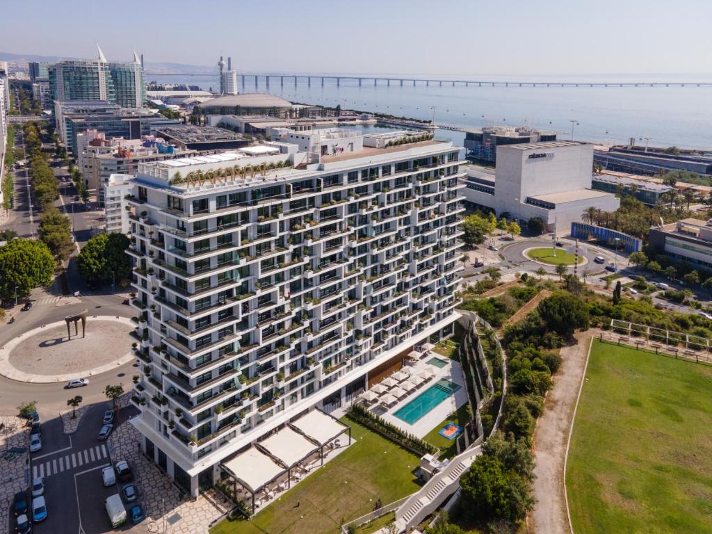 an aerial view of a large building with a pool at Martinhal Lisbon Oriente in Lisbon