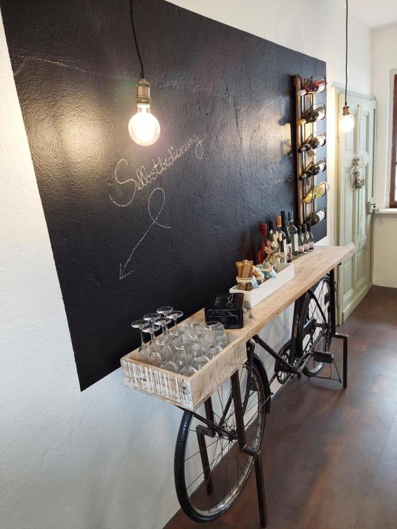 a tasting table with wine glasses on a wall at Koje1 in Bremm