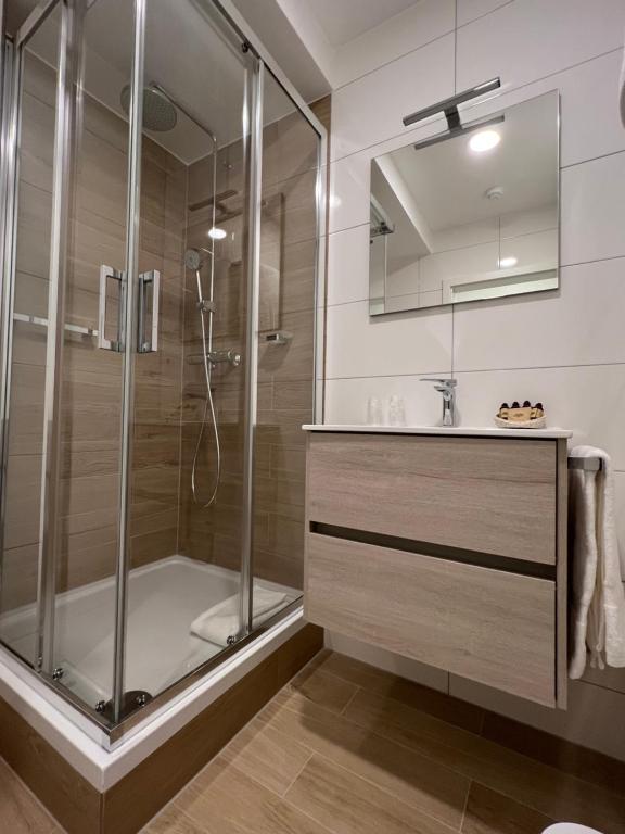 a bathroom with a shower and a sink at Hotel Le Postillon in Echternach