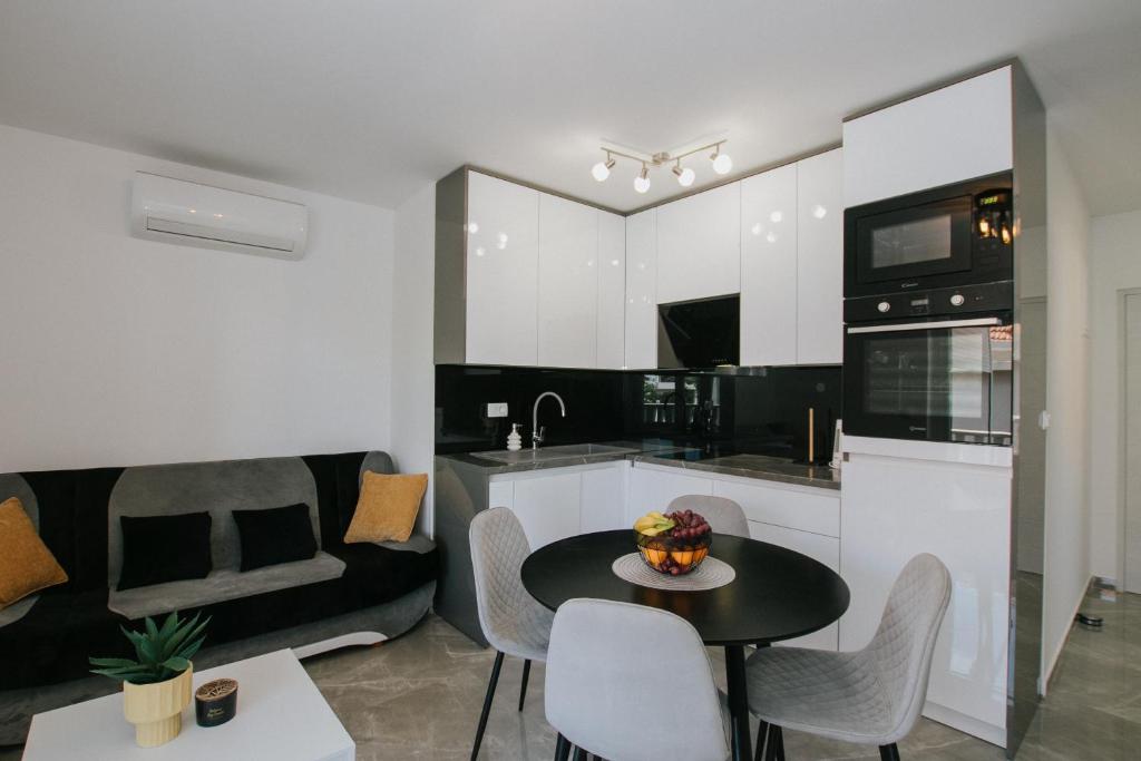a kitchen and living room with a table and chairs at Royal Blue House 2 in Kaštela