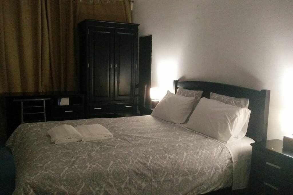 een slaapkamer met een groot bed met 2 witte kussens bij My Colombo Place in Lissabon