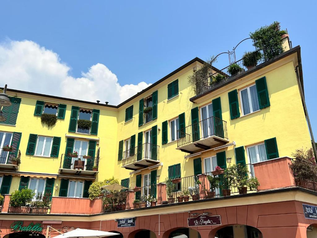 a yellow building with balconies on the side of it at House Sturla by Holiday World in Genova