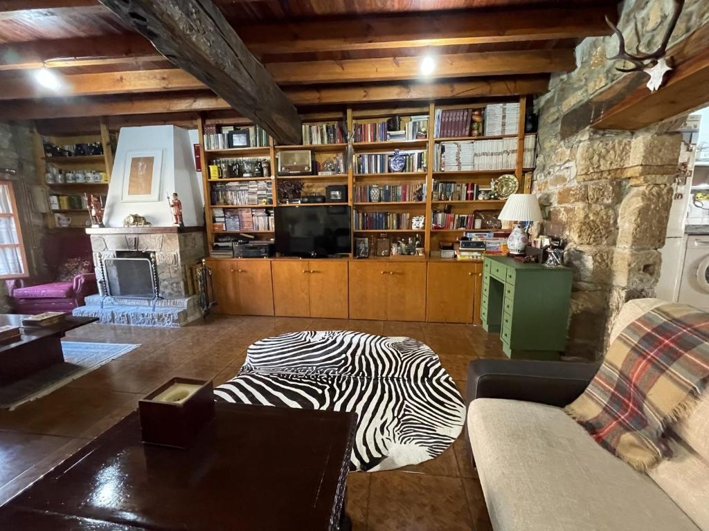 a living room with a zebra laying on the floor at Casa Rustica Con Porche in Bostronizo