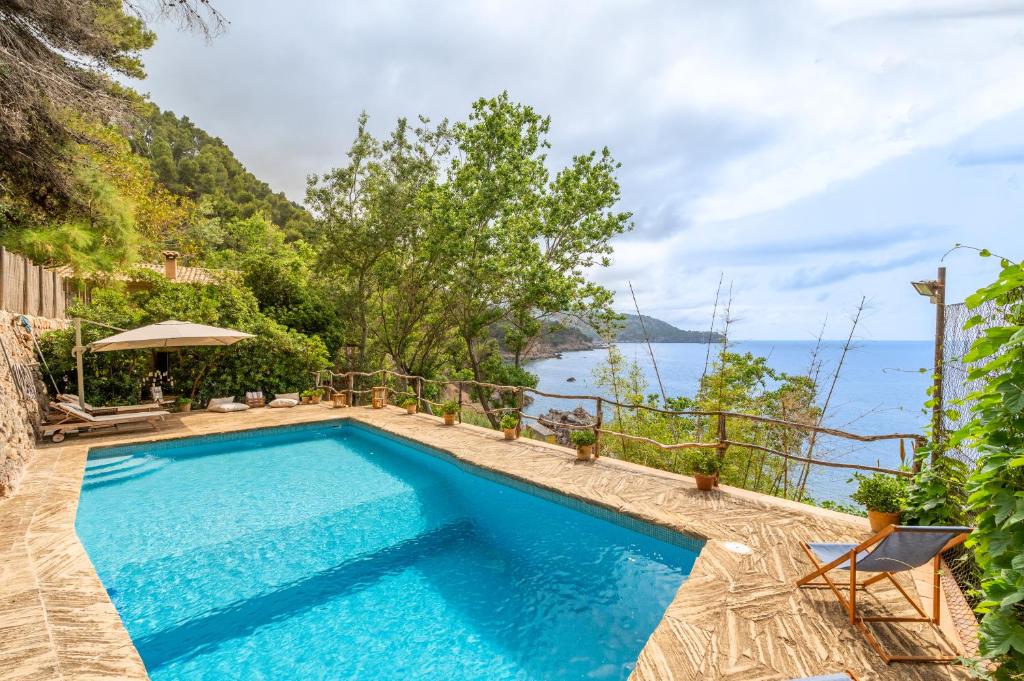 a swimming pool with a view of the water at Alconasser in Sóller