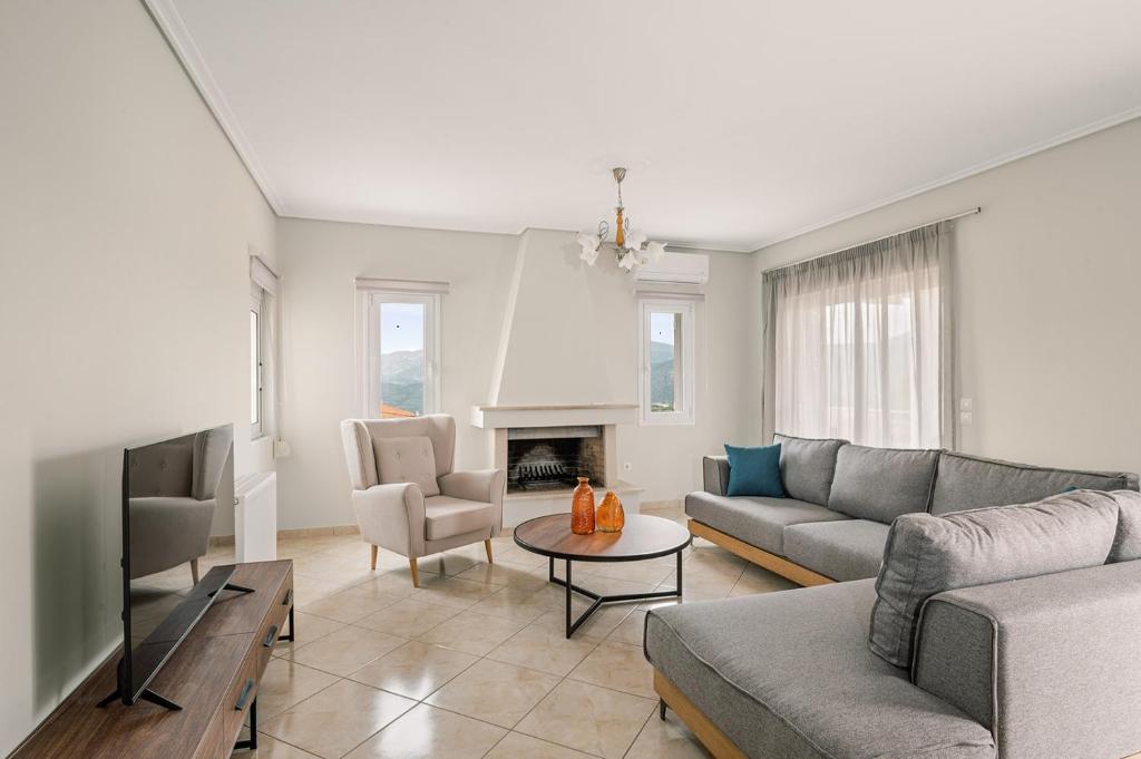 a living room with a couch and a tv at Vasilopoulos Residences - Apartments Eliana & Melanthia in Argostoli