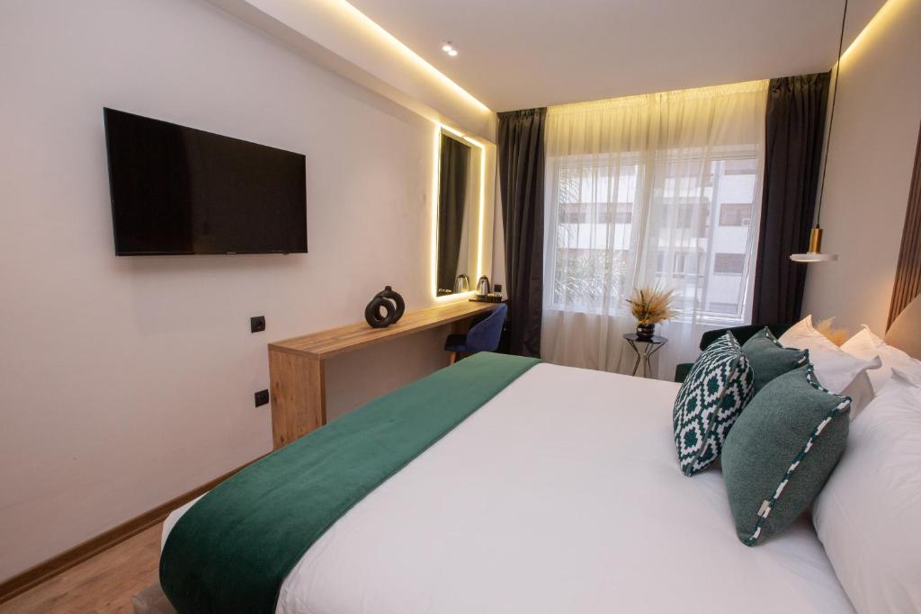Postel nebo postele na pokoji v ubytování Le M Hôtel
