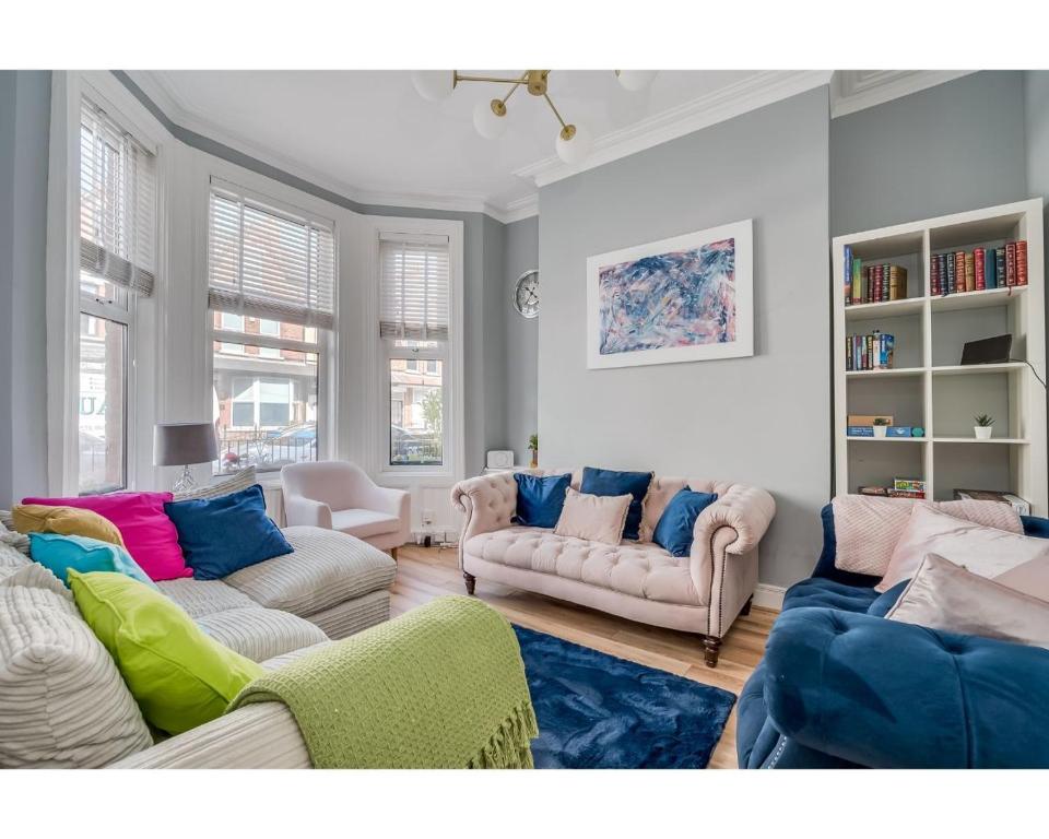 a living room with two couches and two chairs at Central Belfast Apartments Ballyhackamore in Belfast