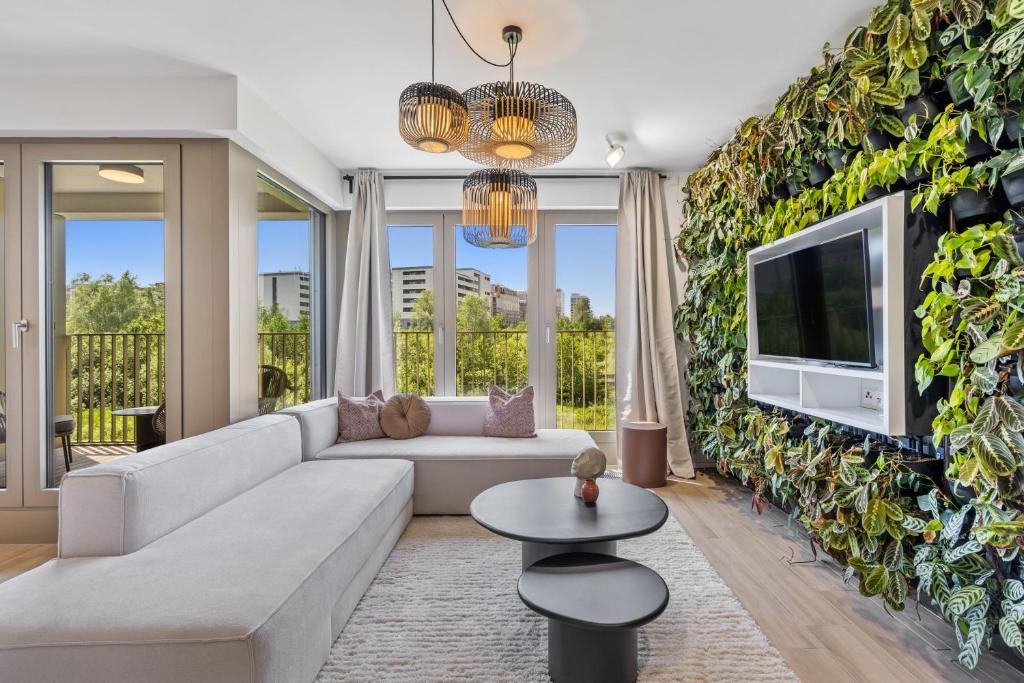 a living room with a large ivy wall at Gem in Historic District Belval in Sanem