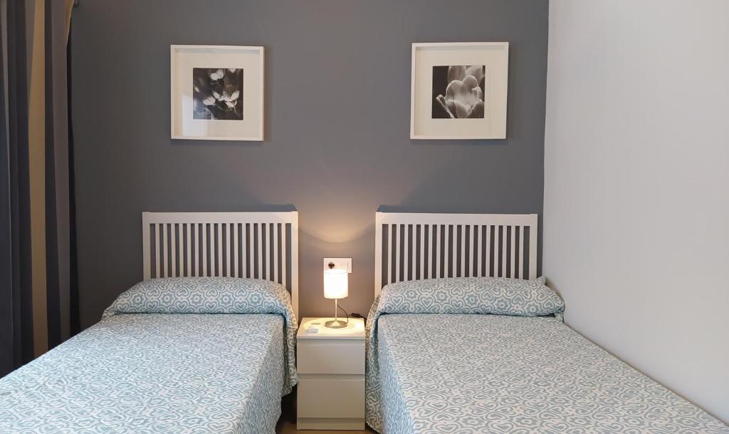 two beds sitting next to each other in a bedroom at Sherryflat Arroyo in Jerez de la Frontera