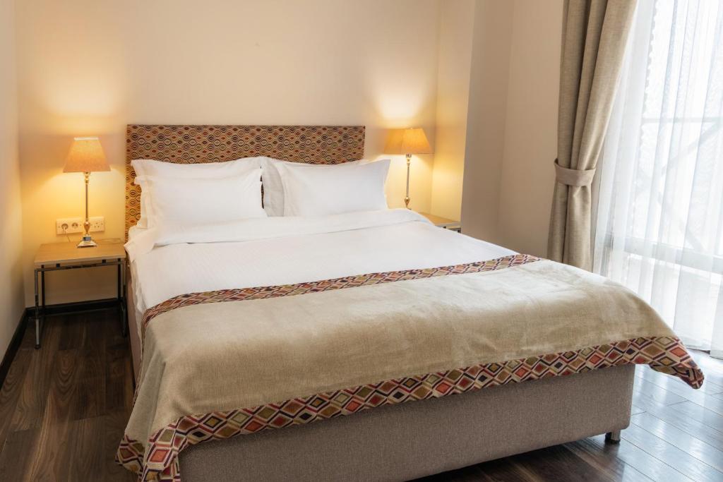 Postel nebo postele na pokoji v ubytování GINGER Hotel
