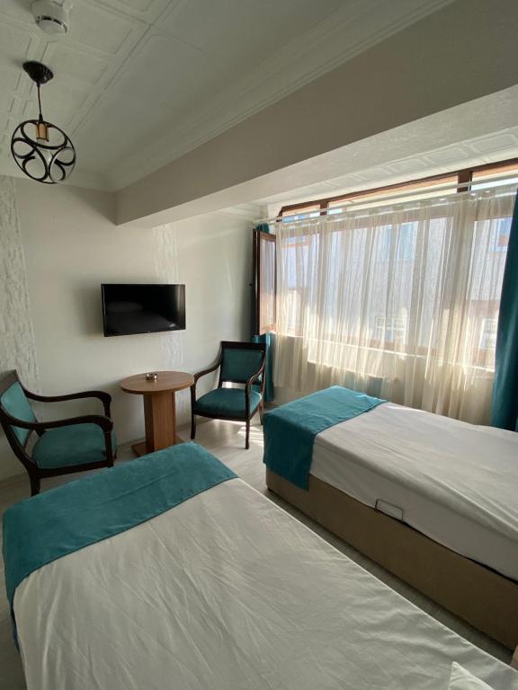 Postel nebo postele na pokoji v ubytování Elite Holiday Hotel