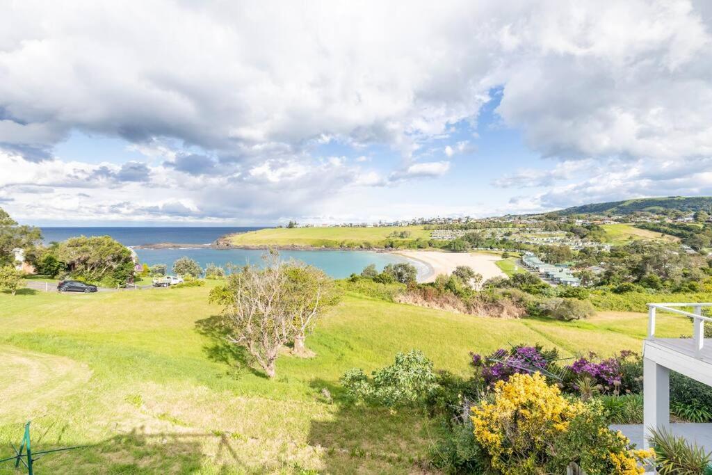 uma vista para o mar a partir de uma casa com um campo verde e um lago em Kiama Beach House & Private Beach & Newly Renovated em Kiama