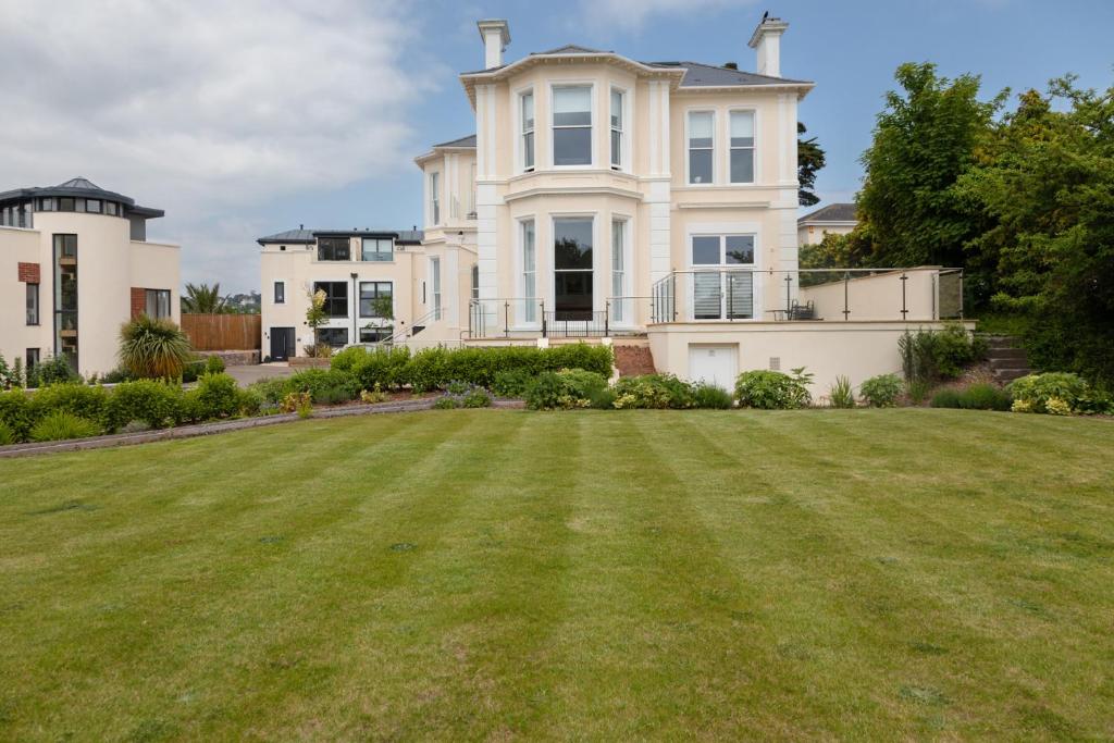 a large yard in front of a large house at Rutland Heights in Torquay